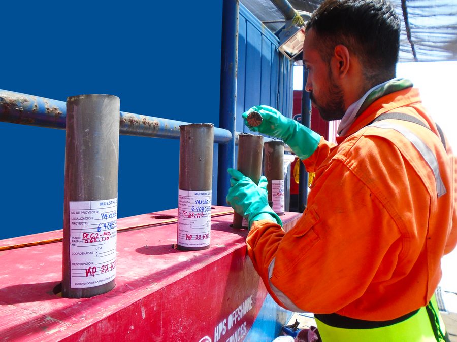 Technician recovering sample cores on deck